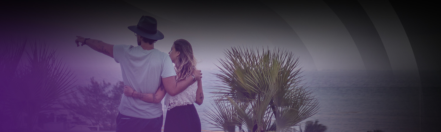 a couple walking near the ocean