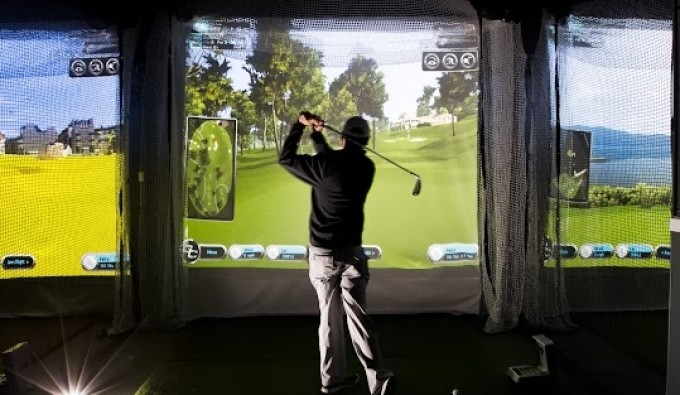 man teeing off at virtual golf