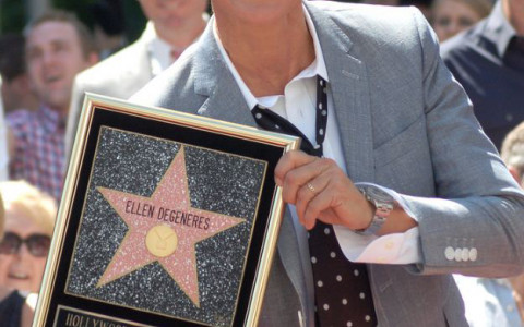 Ellen Degeneres Smiling while holding her star on hollywood walk of fame