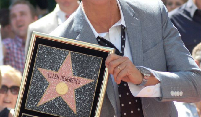 Ellen Degeneres Smiling while holding her star on hollywood walk of fame