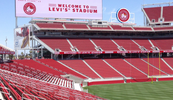 Levi Stadium with sign welcoming fans and red seats and green field