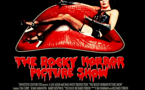 The Rocky Horror Picture Show poster with Tim Curry in costume on a couch shaped like red lips