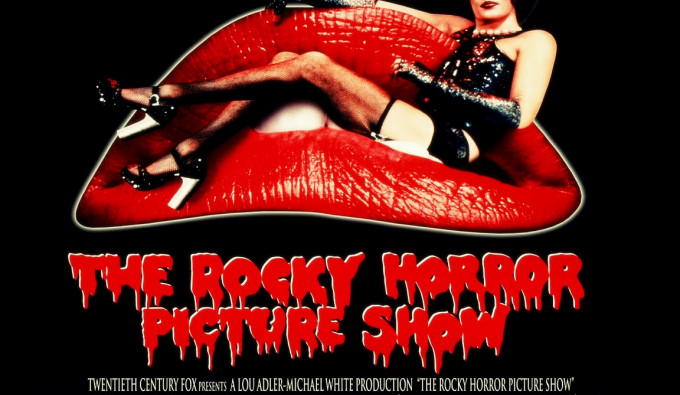 The Rocky Horror Picture Show poster with Tim Curry in costume on a couch shaped like red lips