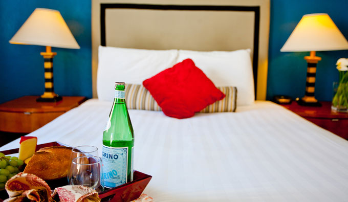room service tray on bed with clean pristine white sheets.