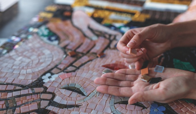artist holding mosaic tiles