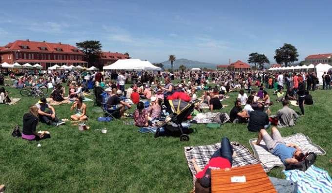 picnic at the presidio. 100's of people set up picnic blankets and tents on a open lawn.