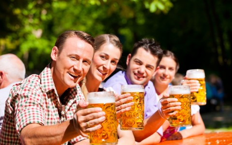 group of friends cheersing beer at camera
