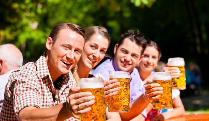 group of friends cheersing beer at camera