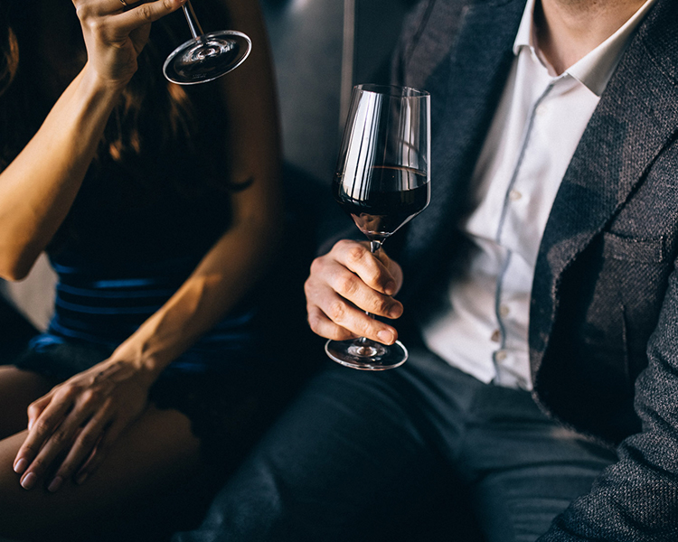 man and woman enjoy glass of red wine 