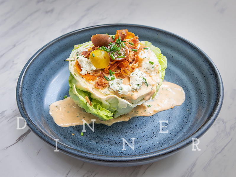 delicious wedge salad on a grey plate 