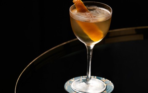 orange cocktail on glass table 