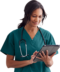 woman doctor smiling while she is searching something in her ipad