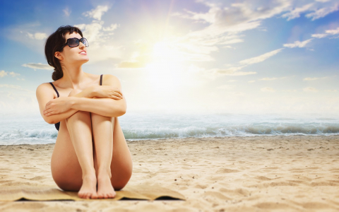 woman sitting on beach
