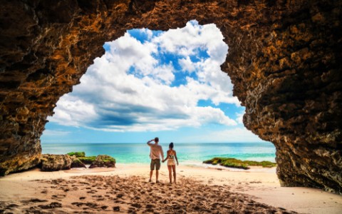Couple in a cave in a beach