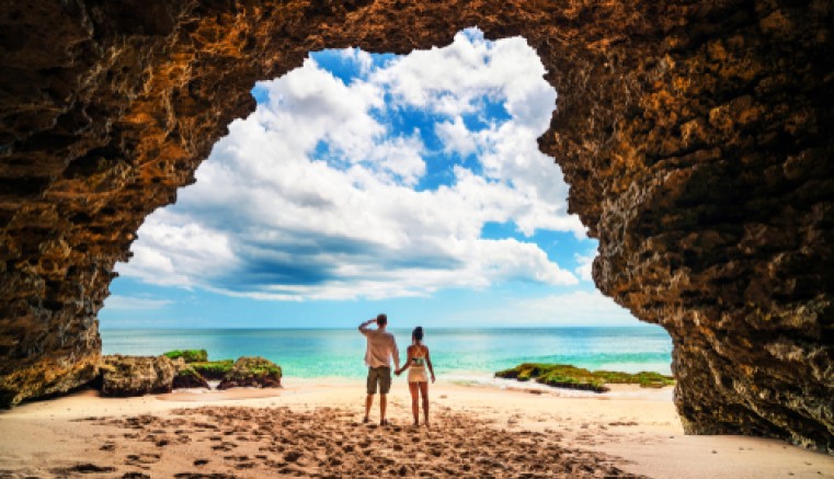 Couple in a cave in a beach