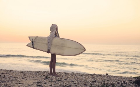 Girl Looking at Waves with Surfboard