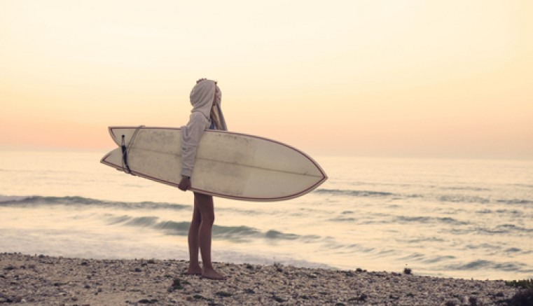Girl Looking at Waves with Surfboard