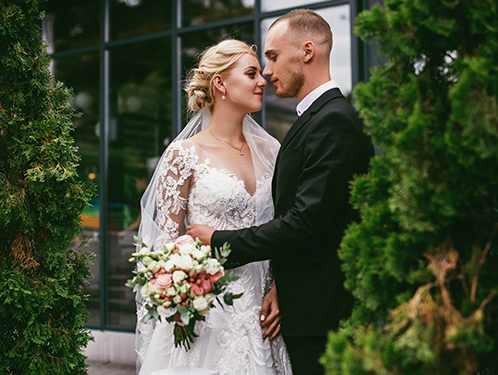 bride and groom embracing outside