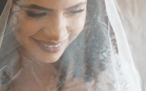 close up of a bride with a veil on 