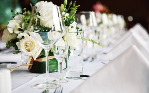 close up of glasses on a white table setting for weddings