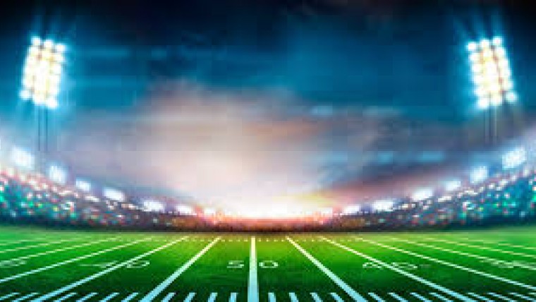 Oklahoma State University Football Stadium at Night with Bright Lights