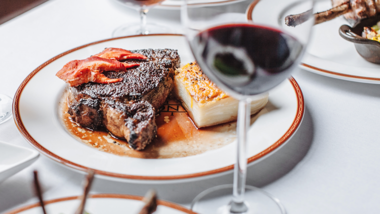 Plated Dinner with Red Wine on a Table