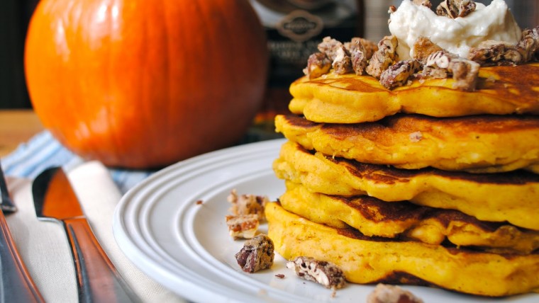 Pumpkin Pancakes with Pumpkin in the background on Placemat