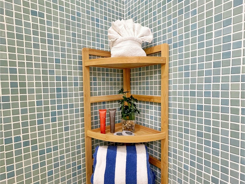 bathroom corner table decorated with towels
