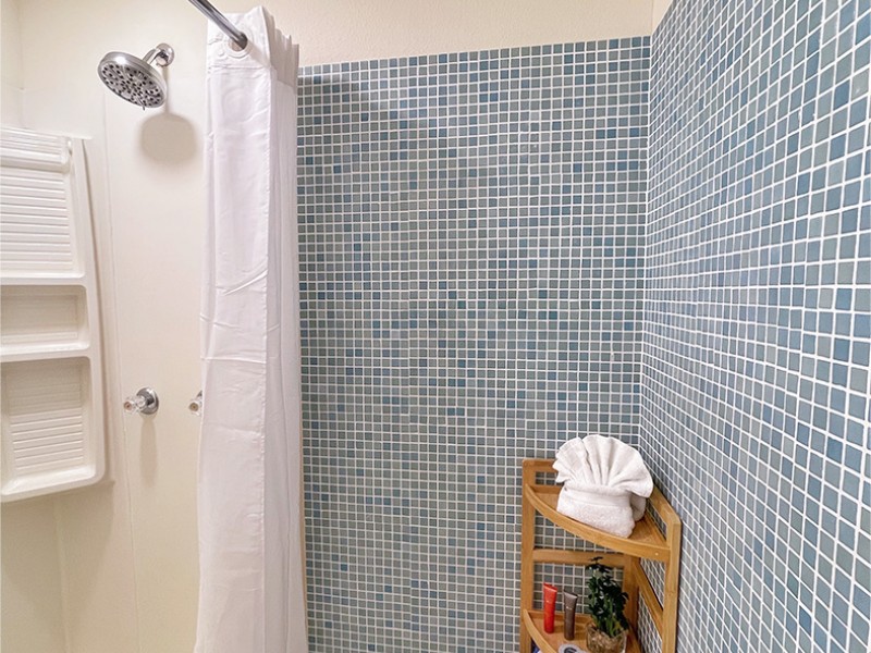 bathroom shower with blue tile
