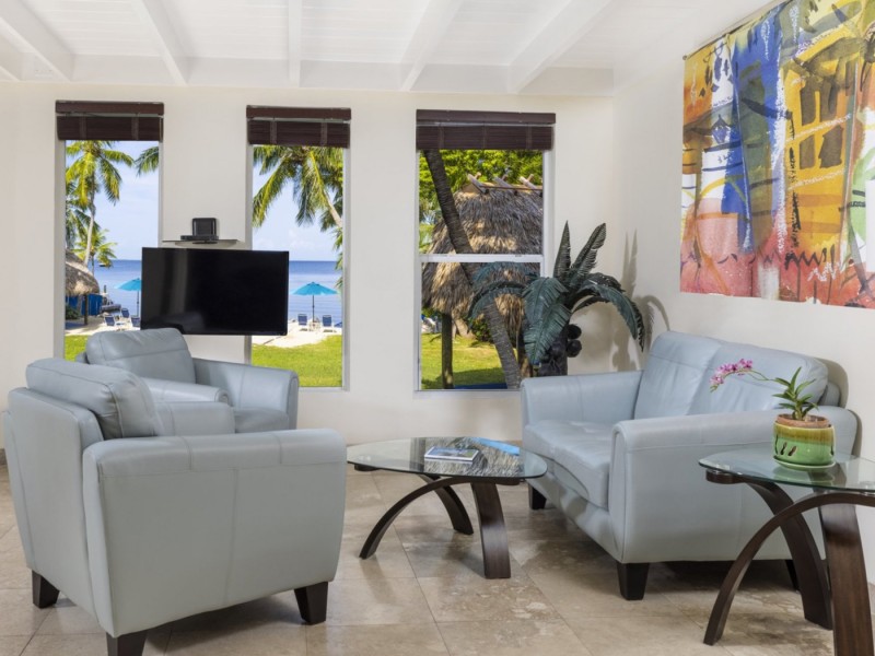 living room with tv and colorful abstract beach painting above couch