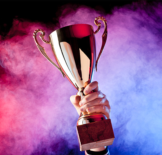 A person holding a tournament cup