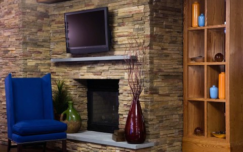 view of hotel common area with fireplace and TV