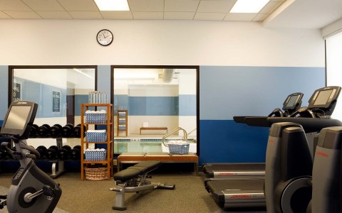 fitness center with treadmill and weights