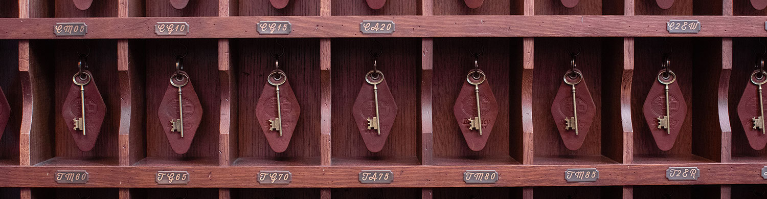 red wooden wall with hotel keys hanging for check in