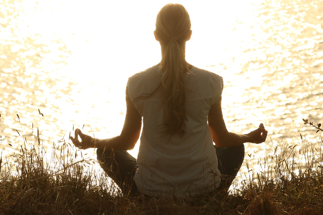 Woman meditating by the water_August 2018