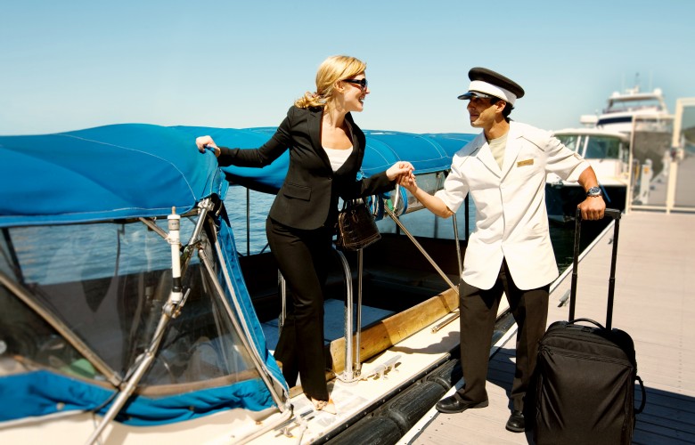 man helping a woman out of a boat