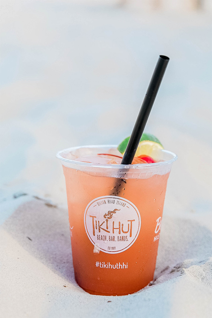 a pink cocktail in the sand 