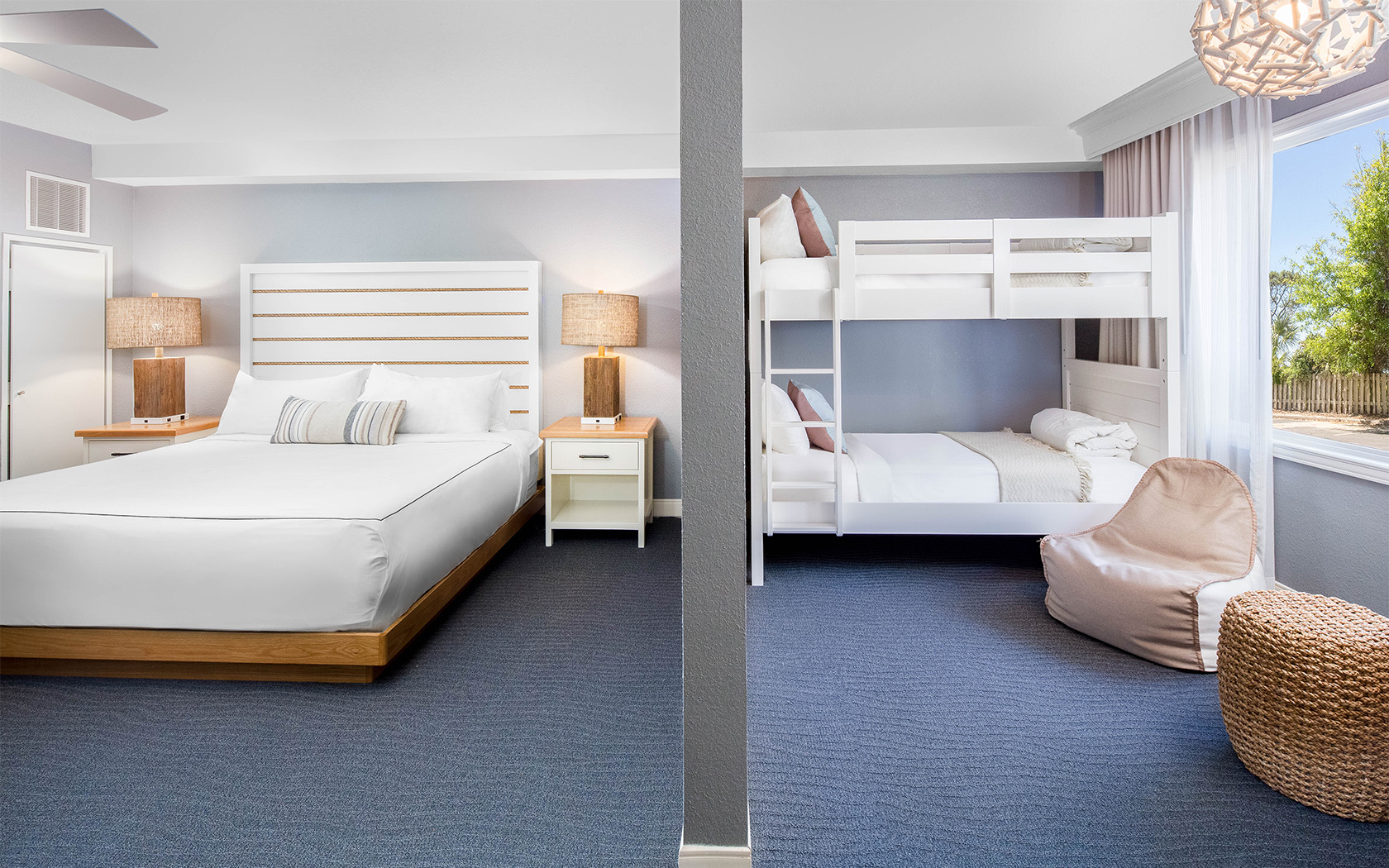 a large room with bunk beds and light blue walls and carpeting