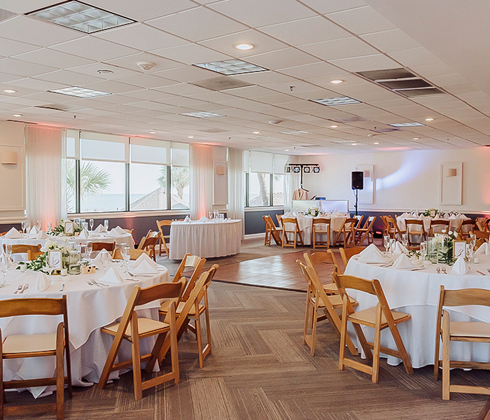a large event room with tables set for dining and a dance floor