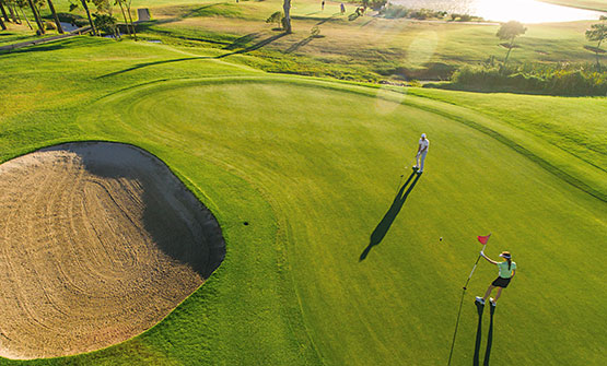 Two people playing on golf course