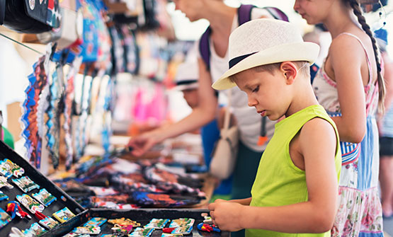 Little boy browsing table at Swap Shop