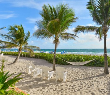 Hammock with three beach chairs overlooking oceanview