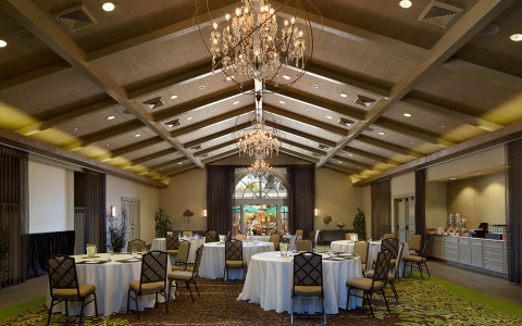 Round tables set up in ballroom with white table cloths