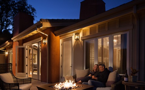 Outdoor fire pit with man and woman sitting next to it