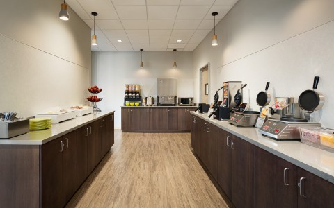 Breakfast Area with Waffle Makers, Cereal, Juices, Toast and Pastries