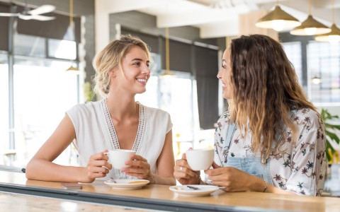 2 Women Having Coffee at a Bar Seat