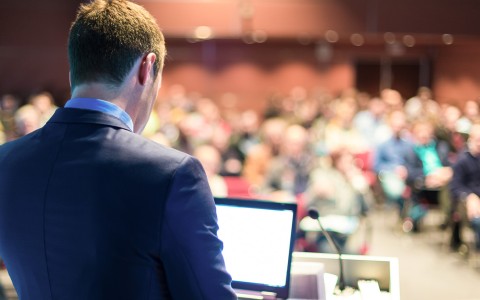 Man Giving Presentation to a Conference Audience