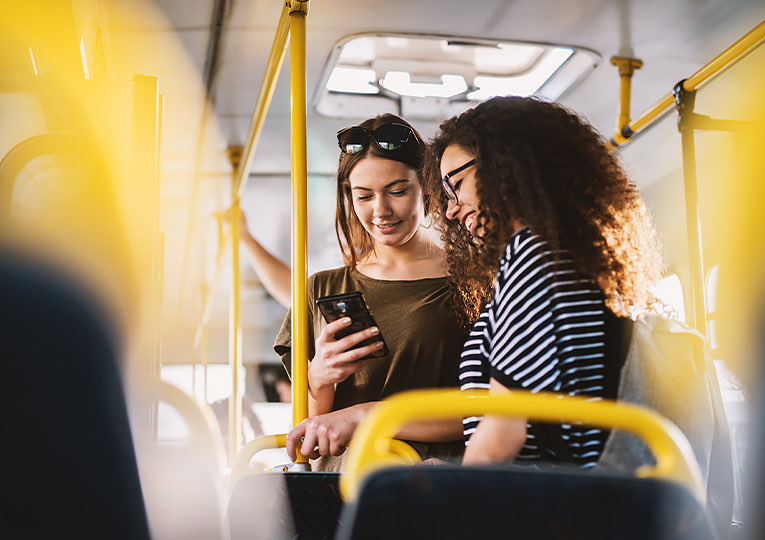 two women chatting on a bus