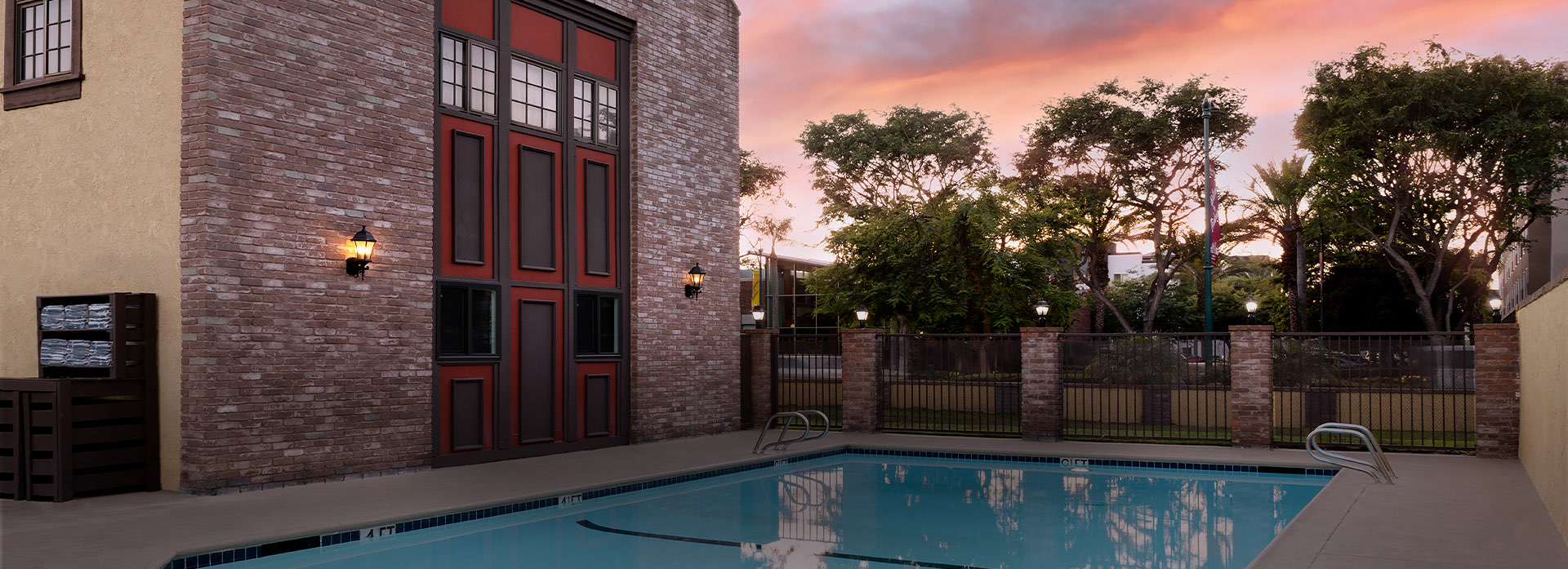 pool and brick building at sunset 