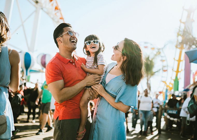 mom and dad holding child